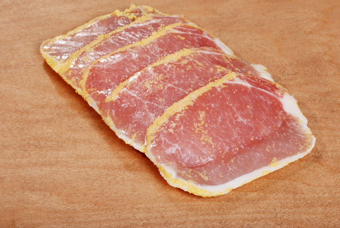peameal bacon on wood cutting board